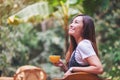 A beautiful asian woman holding and drinking hot coffee in the outdoors Royalty Free Stock Photo