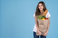 Beautiful Asian woman holding paper shopping bag full of vegetables and groceries Royalty Free Stock Photo