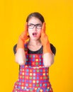 A beautiful Asian woman holds her hand in the head with stress and fatigue in cleaning the house Royalty Free Stock Photo