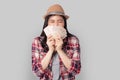 Beautiful Asian woman with long black hair and wearing a hat holding a lot of Thai money She felt happy and wanted to travel.