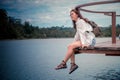 Beautiful asian woman Looking at river & mountains, the weather was great, feeling relaxed. Royalty Free Stock Photo