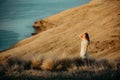 Beautiful asian woman  looking at view in field with sunset at New zealand countryside near the outskirts of Christchurch Royalty Free Stock Photo