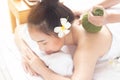 Beautiful asian woman lying massage treatment with happy mood on vacation day.Wellness body care and spa aromatheraphy concept
