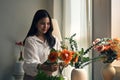 Beautiful Asian woman making a beautiful flower vase filled with beautiful fresh flowers Royalty Free Stock Photo