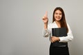 Beautiful asian woman office worker finger empty space isolated on gray background