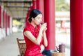 Beautiful Asian  woman in old traditional Chinese dresses drinking tea  in the Temple Royalty Free Stock Photo