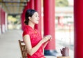 Beautiful Asian  woman in old traditional Chinese dresses drinking tea  in the Temple Royalty Free Stock Photo