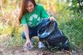 A woman picking up garbage plastic bottles into a box and bag for recycling concept Royalty Free Stock Photo