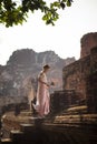 Beautiful asian woman with pink lotus flower standing on ancient Royalty Free Stock Photo