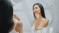 Beautiful Asian Woman Plays and Admires Her Perfect Soft Skin and Lush Black Hair, Looks at Camera Royalty Free Stock Photo