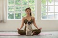 Beautiful Asian woman practice yoga lotus pose with dog pug breed enjoy and relax with yoga in living room at home Royalty Free Stock Photo