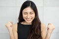 Beautiful Asian woman raising her hands up Royalty Free Stock Photo