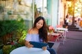 Beautiful asian woman reading a magazine online on tablet at coffee cafe. Royalty Free Stock Photo