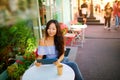 Beautiful asian woman reading a magazine online on tablet at coffee cafe. Royalty Free Stock Photo