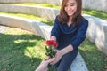 A beautiful asian woman receiving red rose flowers Royalty Free Stock Photo