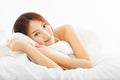 Beautiful asian woman relaxing on the bed Royalty Free Stock Photo