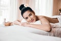 Beautiful Asian woman Relaxing On Massage Table and Smiling Royalty Free Stock Photo