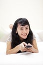 Beautiful Asian Woman with remote control Royalty Free Stock Photo