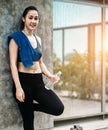 An beautiful Asian woman running, drinking water and listening music Royalty Free Stock Photo