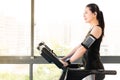 Beautiful asian woman running treadmill use smartphone listening Royalty Free Stock Photo