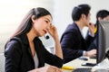 Beautiful asian woman Serious call center operator in wireless headset talking with customer,in customer support service Royalty Free Stock Photo