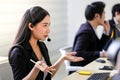 Beautiful asian woman Serious call center operator in wireless headset talking with customer,in customer support service Royalty Free Stock Photo