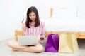 Beautiful of asian woman shopping online with laptop computer sitting on floor on room Royalty Free Stock Photo