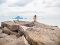 Beautiful asian woman with short hair using smart phone take a photo seascape view