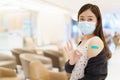 Beautiful Asian woman showing a vaccination injection point at her arm. Royalty Free Stock Photo