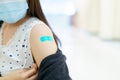 Beautiful Asian woman showing a vaccination injection point at her arm. Royalty Free Stock Photo