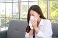 Beautiful asian woman sick with the flu have a stuffy nose Hold a tissue to cover your mouth. Royalty Free Stock Photo