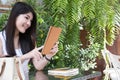 Asian woman sit at outdoor cafe. young female adult use digital Royalty Free Stock Photo