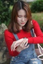 Beautiful Asian woman with long hair looking at her watch Royalty Free Stock Photo