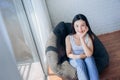 Beautiful Asian woman sitting on Black Sofa Relax