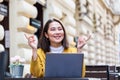 Beautiful Asian woman sitting with portable net-book laptop in modern cafe bar, young charming asian female freelancer thinking Royalty Free Stock Photo