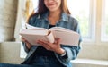 A beautiful asian woman sitting and reading book at home Royalty Free Stock Photo