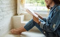 A beautiful asian woman sitting and reading book at home Royalty Free Stock Photo