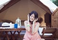 Beautiful asian woman sitting at tent and drinking coffee in the morning,Enjoys of resting time,Happy and smiling Royalty Free Stock Photo