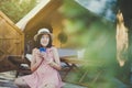 Beautiful asian woman sitting at tent and drinking coffee in the morning,Enjoys of resting time,Happy and smiling Royalty Free Stock Photo