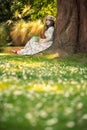 Beautiful asian woman sitting under the tree in the park Royalty Free Stock Photo