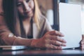 A beautiful Asian woman with smiley face holding and using tablet pc for take a picture