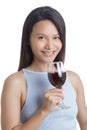 Beautiful Asian woman smiling and holding glass of red wine Royalty Free Stock Photo