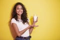 Beautiful asian woman smiling while prresenting a glass of milk Royalty Free Stock Photo