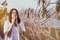 Beautiful asian woman sneezes because of allergy with flower at nature