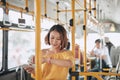 Beautiful asian woman standing in the bus checking time on her watch Royalty Free Stock Photo