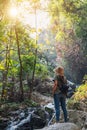 A woman standing in front of waterfall in the jungle Royalty Free Stock Photo