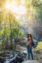 A woman standing in front of waterfall in the jungle Royalty Free Stock Photo