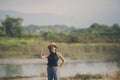 beautiful asian woman standing on open land scape and raising right thumb with good feeling Royalty Free Stock Photo