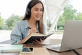 Beautiful Asian woman student excited check language test result on laptop. Smile girl happy study online. Portrait female on Royalty Free Stock Photo