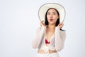 A beautiful Asian woman in summer clothes and a straw hat is showing wow excited facial expression